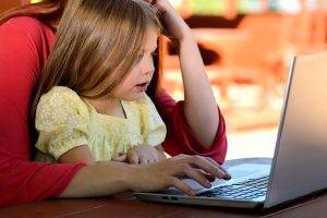 child mom working at computer